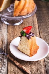 Bundt cake with chocolate ganache glaze and fresh strawberries