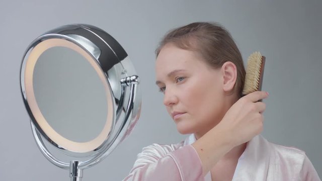 panned video of woman combing her hair