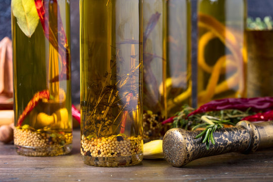 Bottles of olive oil with different spices and herbs.