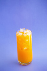 Orange juice splashing isolated on a color background