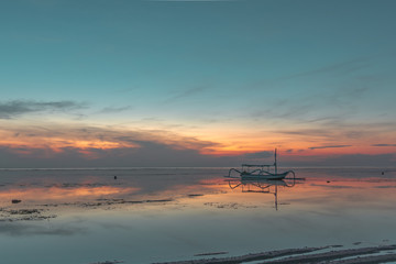An old traditional indonesian fishing boat at sunrise