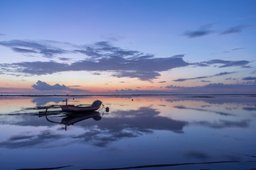 Fototapeta na wymiar traditional balinese fishing boat in the first blue morning light