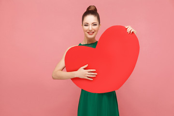 Happiness woman embrace big red heart, toothy smiling