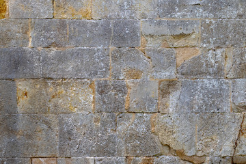 Surface of an old grey brick wall 