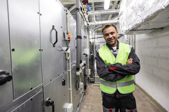 Worker in electrical switchgear room