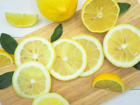 Fresh lemon slice on white wood background