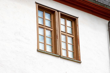 Single wooden window in an outer wall of a big house