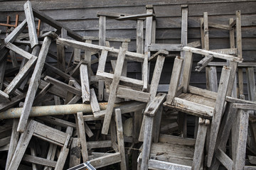 Broken vintage wooden chairs in old school