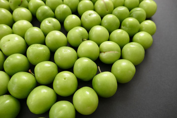 green sour plums,wonderful fresh green plums on black ground
