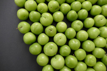 green sour plums,wonderful fresh green plums on black ground
