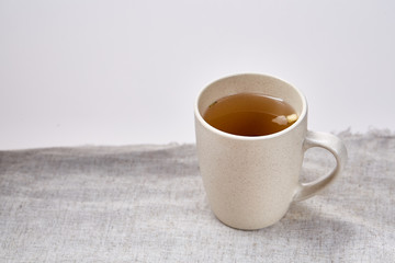 Cup of tea on table with sackcloth, top view, close-up, selective focus
