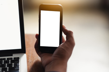 Cropped shot view of man's hands holding smart phone with blank copy space screen for your text message or information content, female reading text message on cell telephone during in urban setting