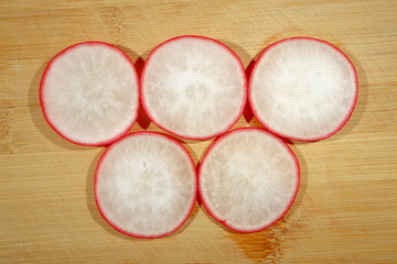 A piece of radish on a wooden Board