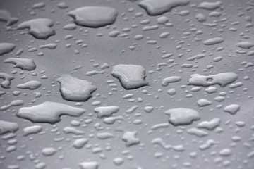 drops of water on a gray metal surface