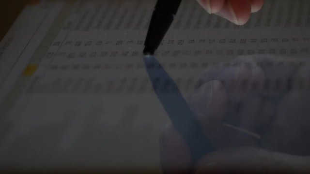using a stylus pen to scroll down a touch screen of data