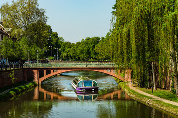 Fototapeta na wymiar Travel boat in Strasbourg . Reflections in the river Ill