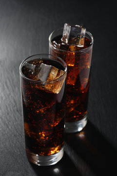 Glasses of cola on black board