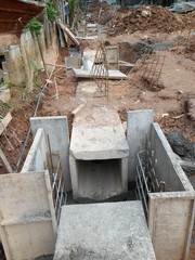 Underground drainage manhole under construction by construction workers at the construction site. The manhole design based on infrastructure engineer design.