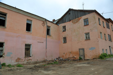 Part of the facade of an abandoned old stone house

