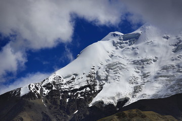Snowcapped peak and blue sky with clouds in the Himalaya mountains Tibet