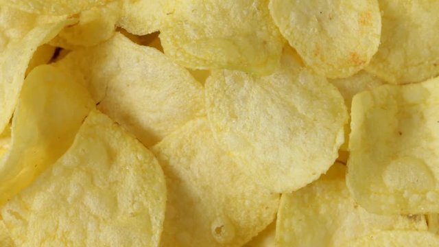 Close up of rotating potato chips. No sound.