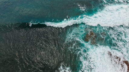 Aerial view from a surf spot with waves and a group of surfers in Ericeira, Portugal