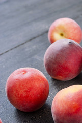 Fototapeta na wymiar ripe homegrown peaches on black wooden table