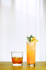 A single Whiskey and Paloma Cocktail on the center of copper counter top, in front of a defocused window with white plain curtain, without decoration, simple background, ambient nature day lighting 2