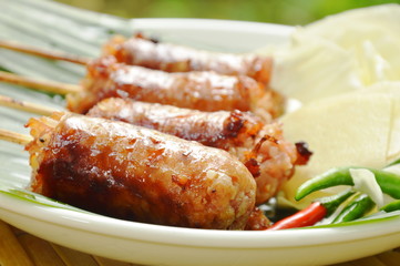grilled Thai sausage stuffed rice and pork eat with fresh vegetable on plate