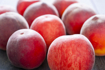 ripe homegrown peaches on black wooden table
