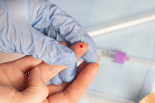 Blood sampling from the finger, close-up, finger and blood