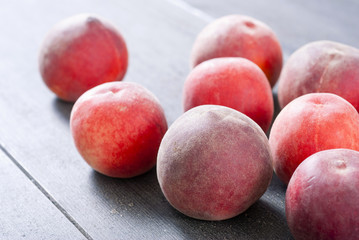 ripe homegrown peaches on black wooden table