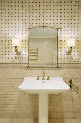 Sink with a mirror in the toilet in a luxurious room in a classic style