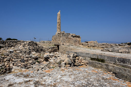 Greece, Aegina: Famous temple of Apollo in midday sun with column and blue sky. Aegina is one of the Saronic Islands of Greece in the Greek Saronic Gulf.