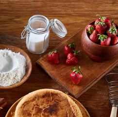 Recipe for strawberry pie, strawberry for cooking cake on cutting board over wooden background, selective focus