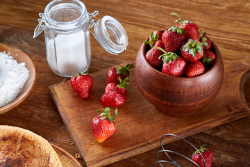 Recipe for strawberry pie, strawberry for cooking cake on cutting board over wooden background, selective focus