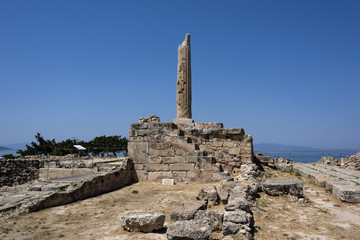 Greece, Aegina: Ruin of famous Temple of Apollo with sun, collumn and blue sky - concept history travel. The patron of Delphi, Apollo was an oracular god, the prophetic deity of the Delphic Oracle.