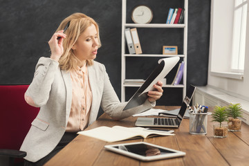 Concentrated businesswoman working on laptop at office