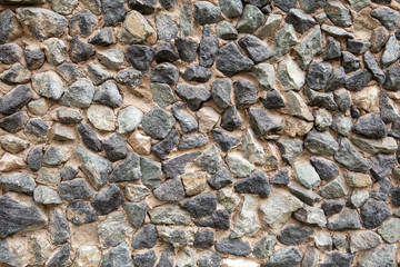 texture of wall made of stones on concrete