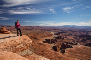 Fototapeta premium Hiker rests in Canyonlands National park in Utah, USA