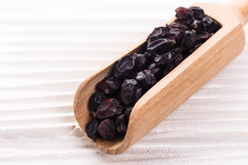 dried barberry berries on the rustic background