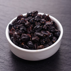 dried barberry berries on the rustic background