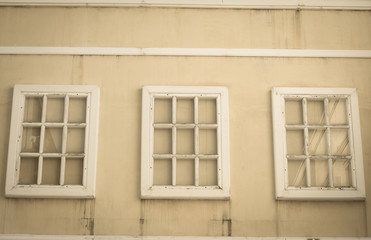 White window on yellow wall.