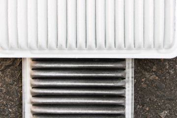 Old and new car air filter. Close up
