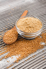 mustard in a bowl on a rustic background