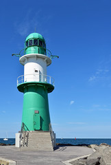 Fototapeta na wymiar Lighthouse on the western pier in Warnemünde in Germany