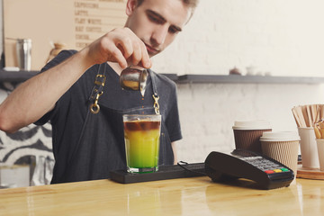 Concentrated bartender making coffee cocktail