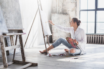 Woman painter at workspace.