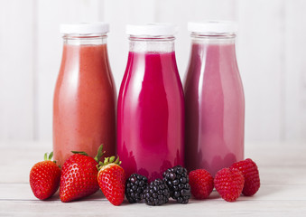 Glass bottle with fresh summer berries smoothie