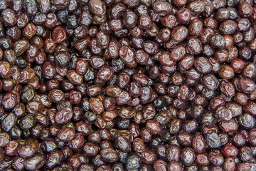 Background of black olives in pickle, sold on the market